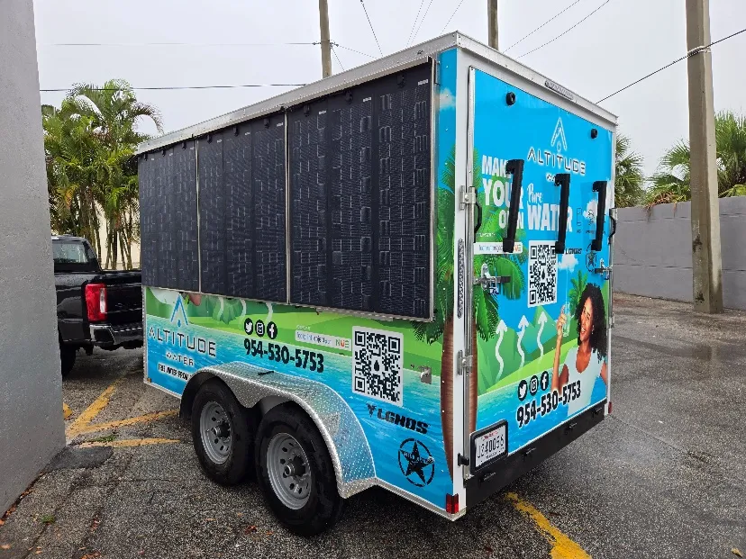The Altitude Water Disaster Relief Trailer, with solar panels along its roof, which makes drinking water from the air